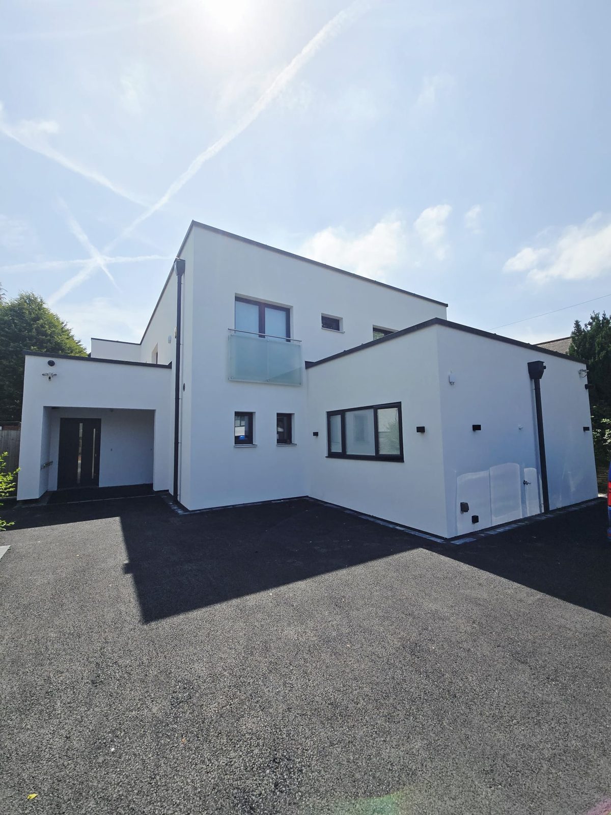 Modern white rendered house refurbished with full disability adaptations in Whitefield