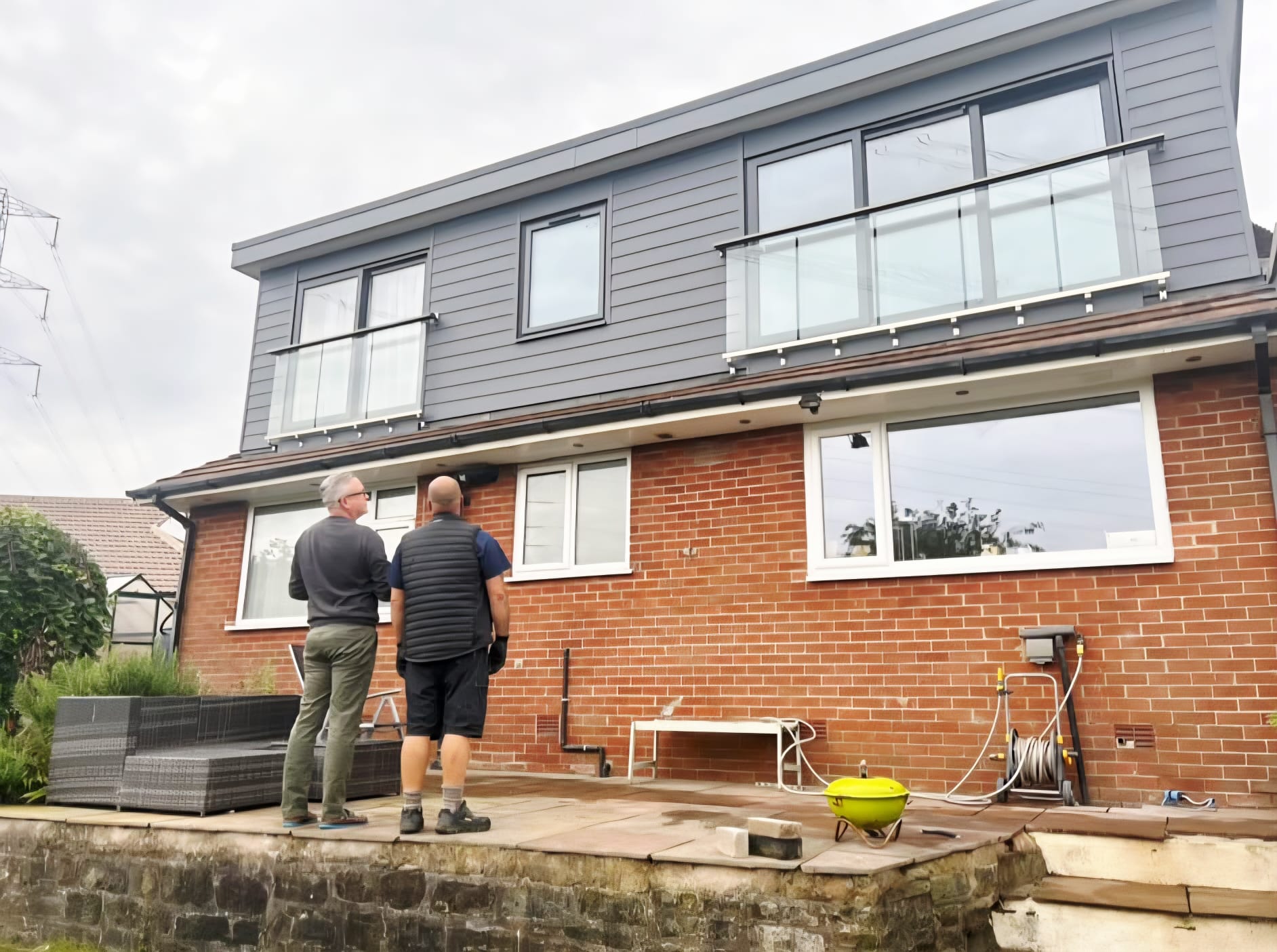 Completed dormer loft conversion in Bamford, homeowners viewing the finished work