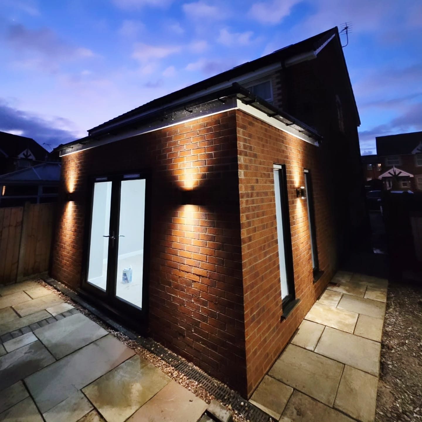 Completed single storey extension in Castleton, lit at dusk