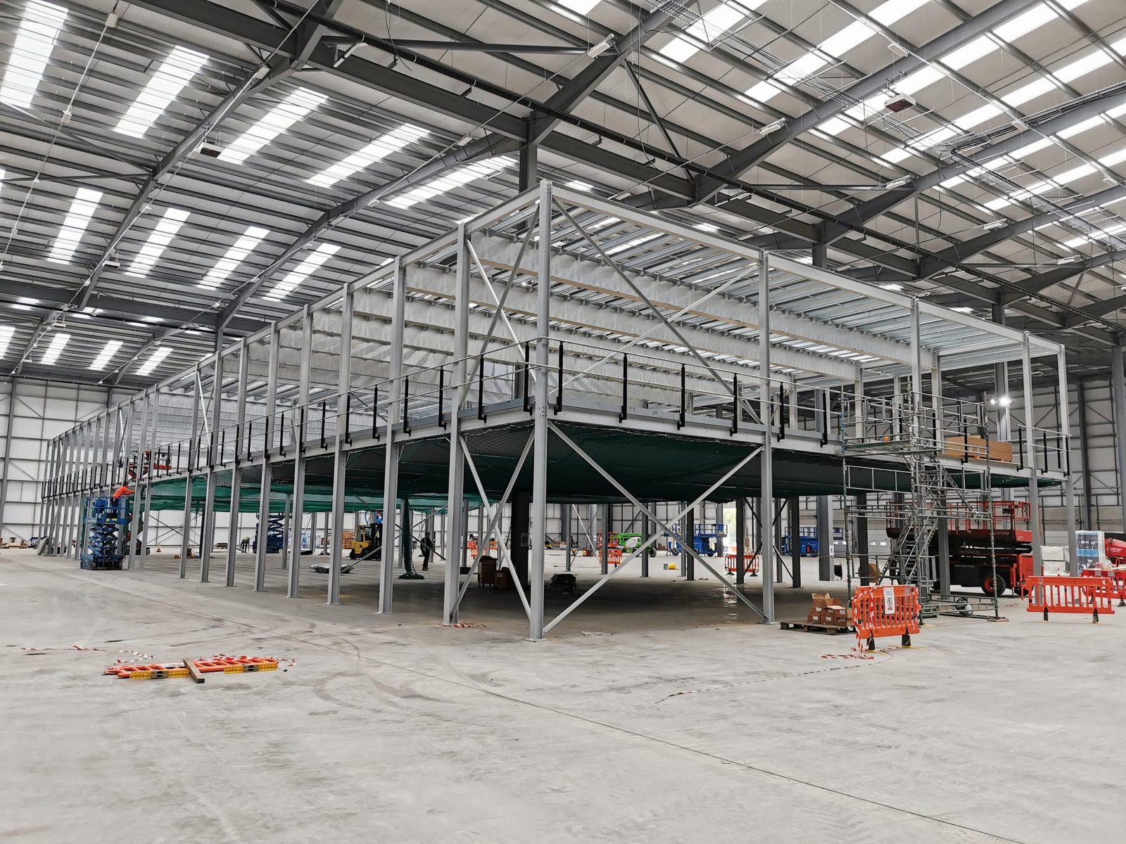 Completed steel mezzanine deck with green edge protection spanning the distribution unit